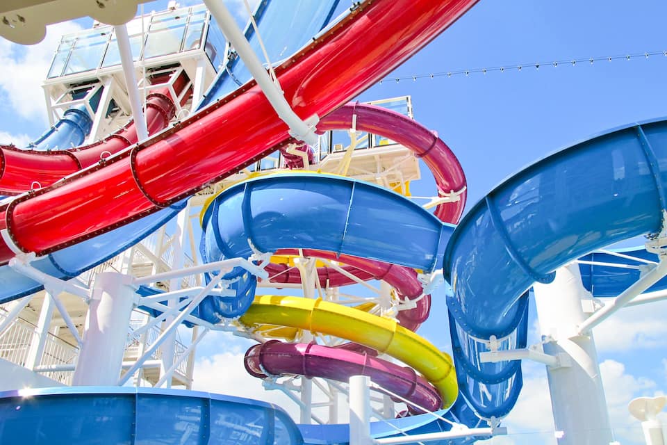A water park with multiple slides in red, blue, yellow, and purple colors.