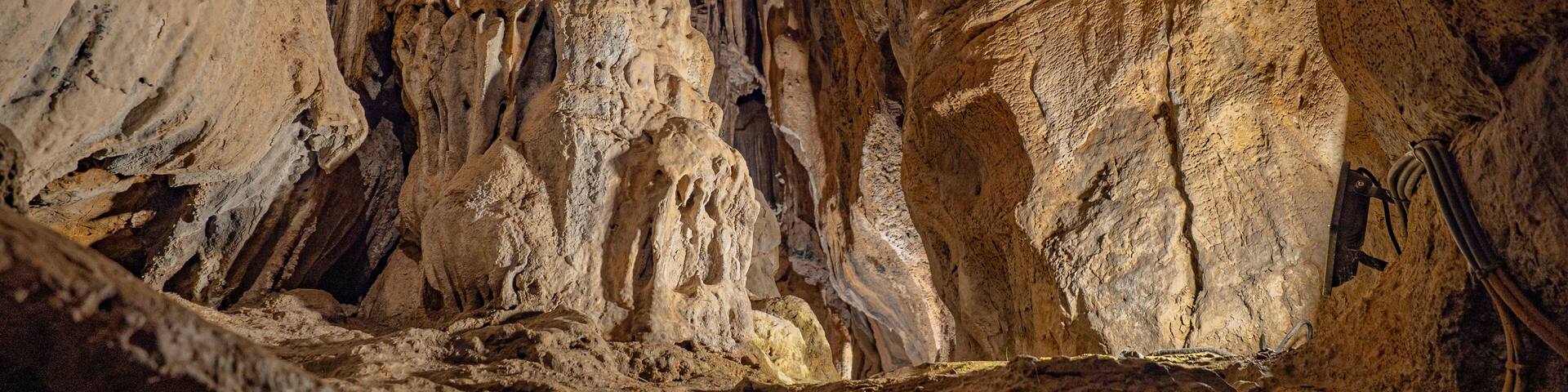 Rocks of one of the routes of the caves of San José; caves with huge lakes located in Spain. Geological expedition. The longest underground river in Europe dating back to the Triassic.