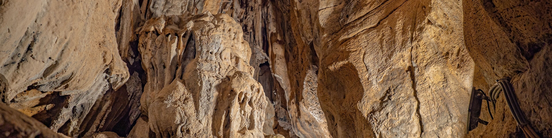 Rocks of one of the routes of the caves of San José; caves with huge lakes located in Spain. Geological expedition. The longest underground river in Europe dating back to the Triassic.