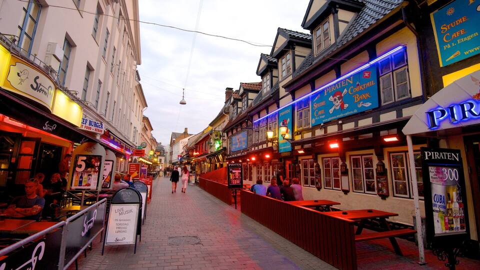 Jomfru Ane Gade showing heritage architecture, outdoor eating and signage