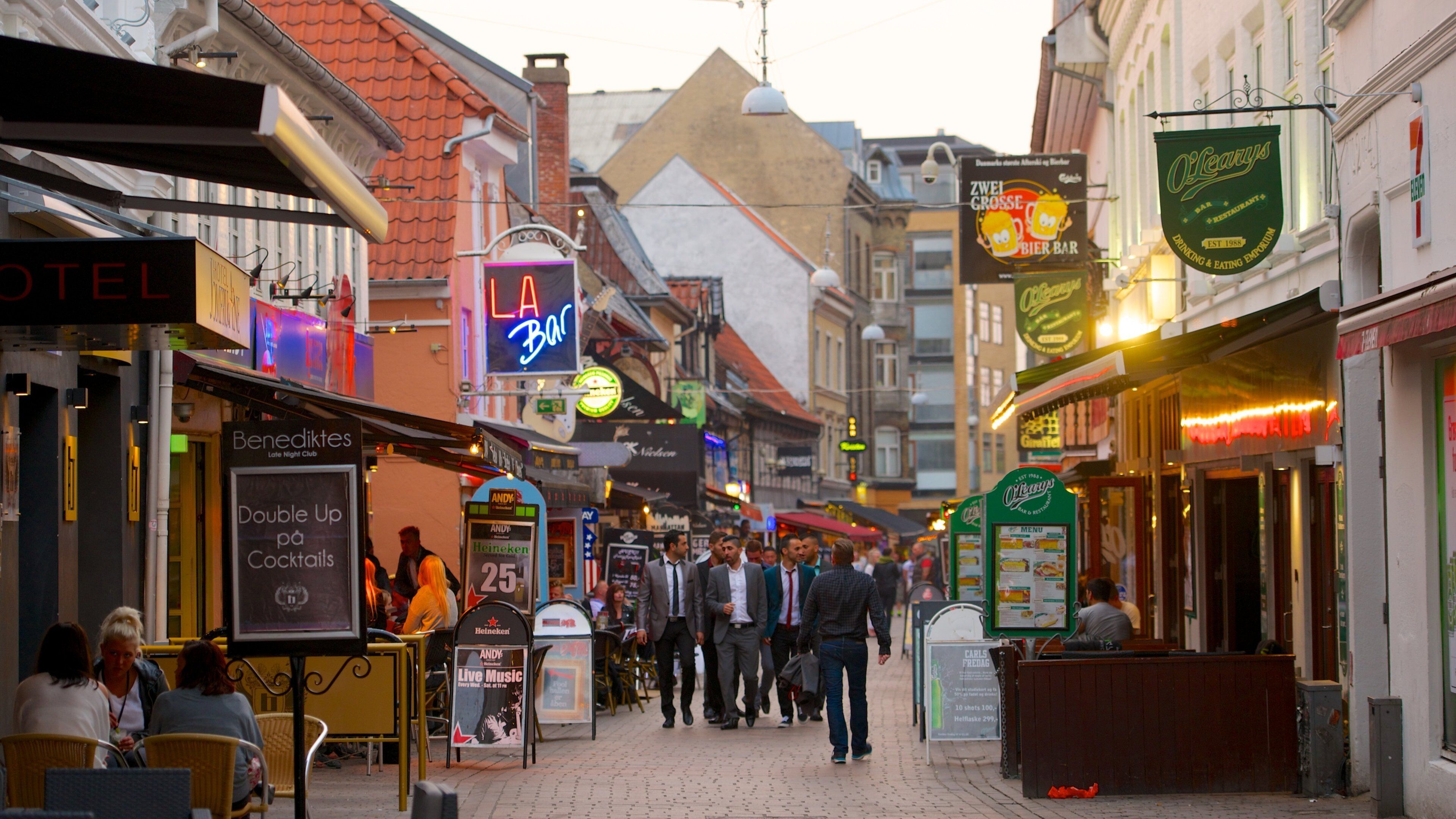 Jomfru Ane Gade showing signage, a city and outdoor eating