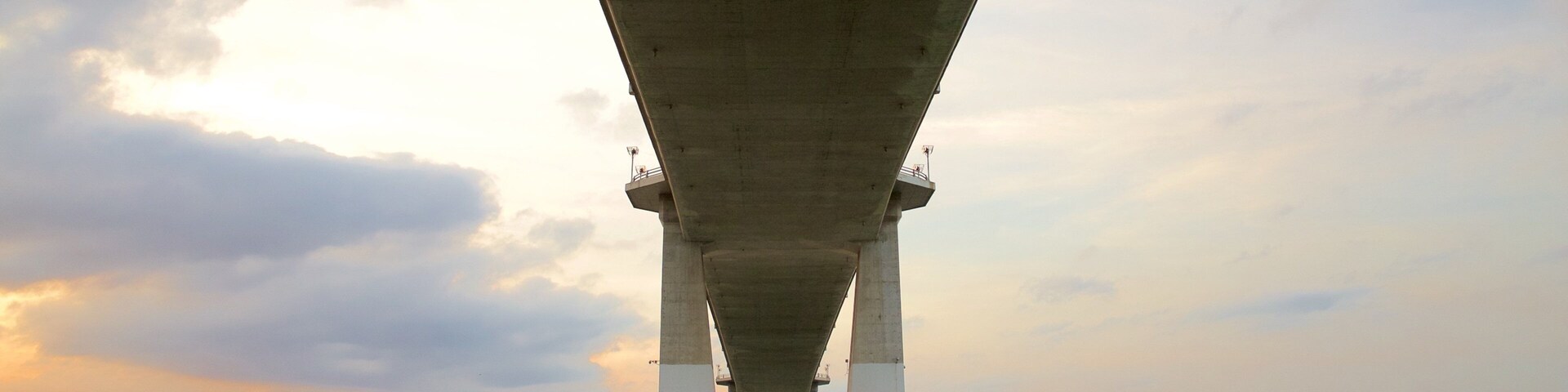 Marcelo Fernan Bridge which includes a bridge, a river or creek and a sunset