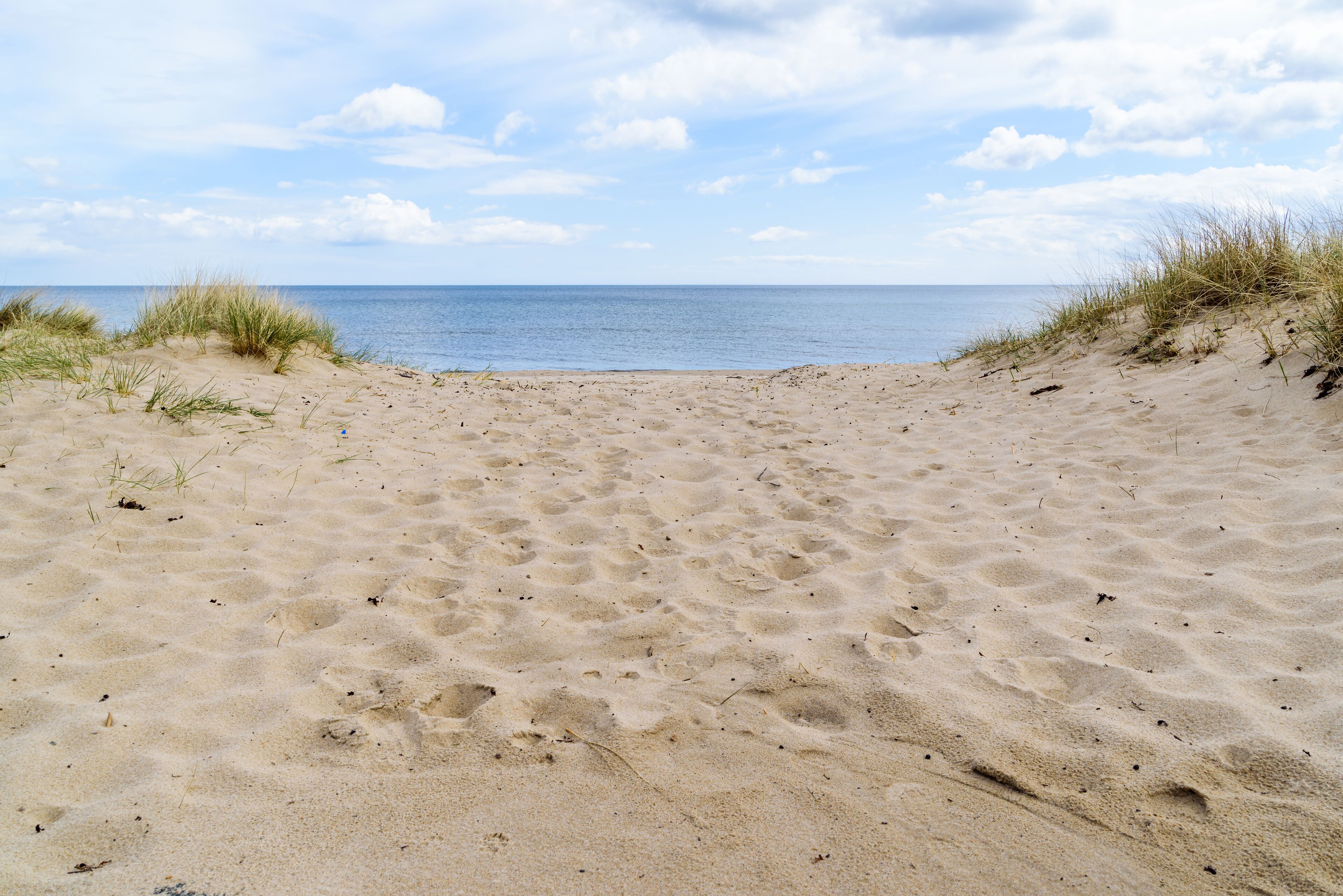 Ynsjo, Sweden. Sandy beach with the sea behind it.