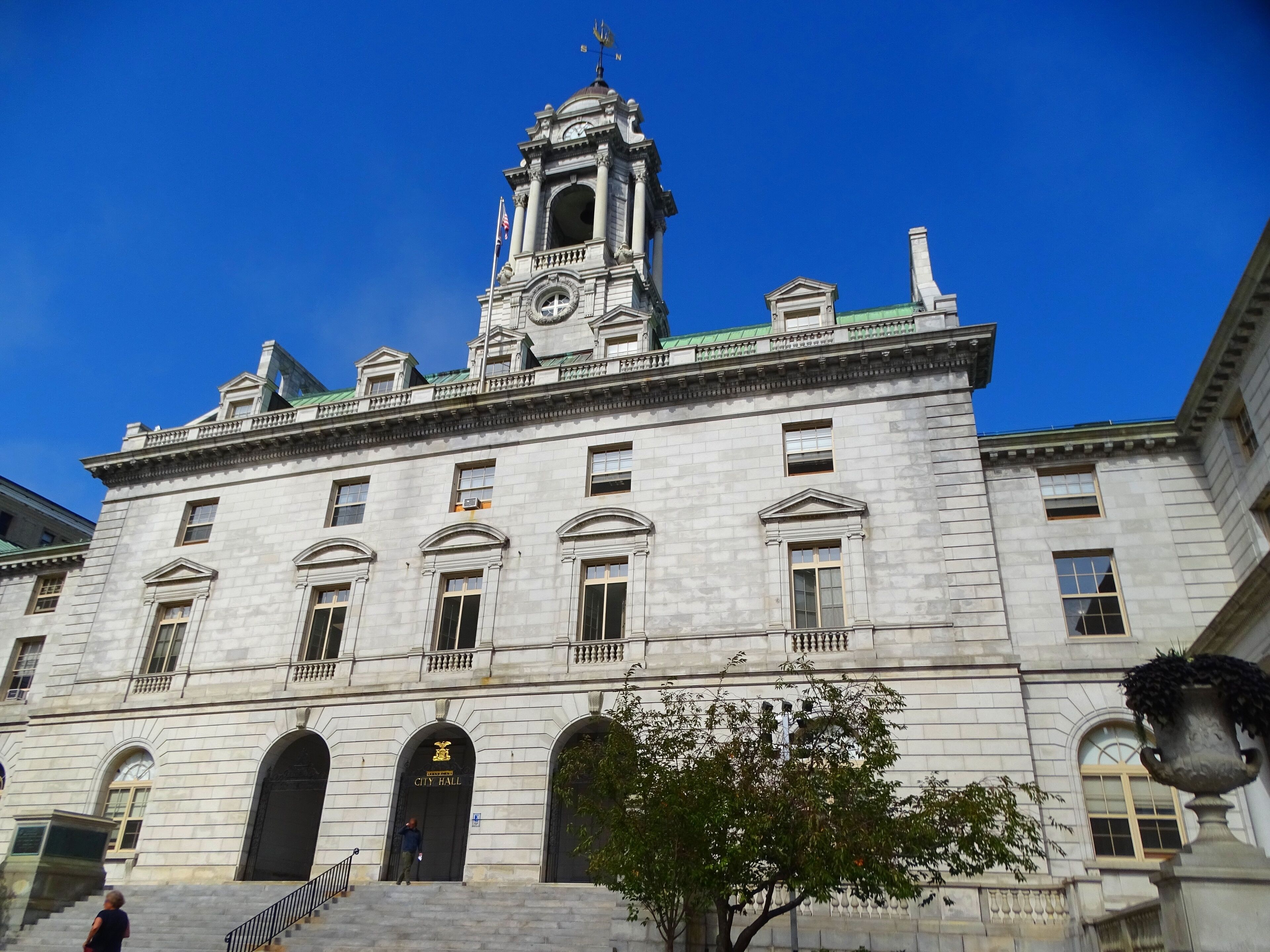 A large, historic building with a prominent clock tower and arched windows.