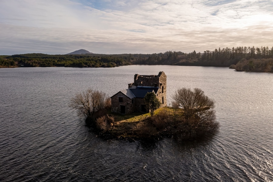 Ballynahinch Castle in the centre of the Lake at the golden hour. Connemara, Galway.