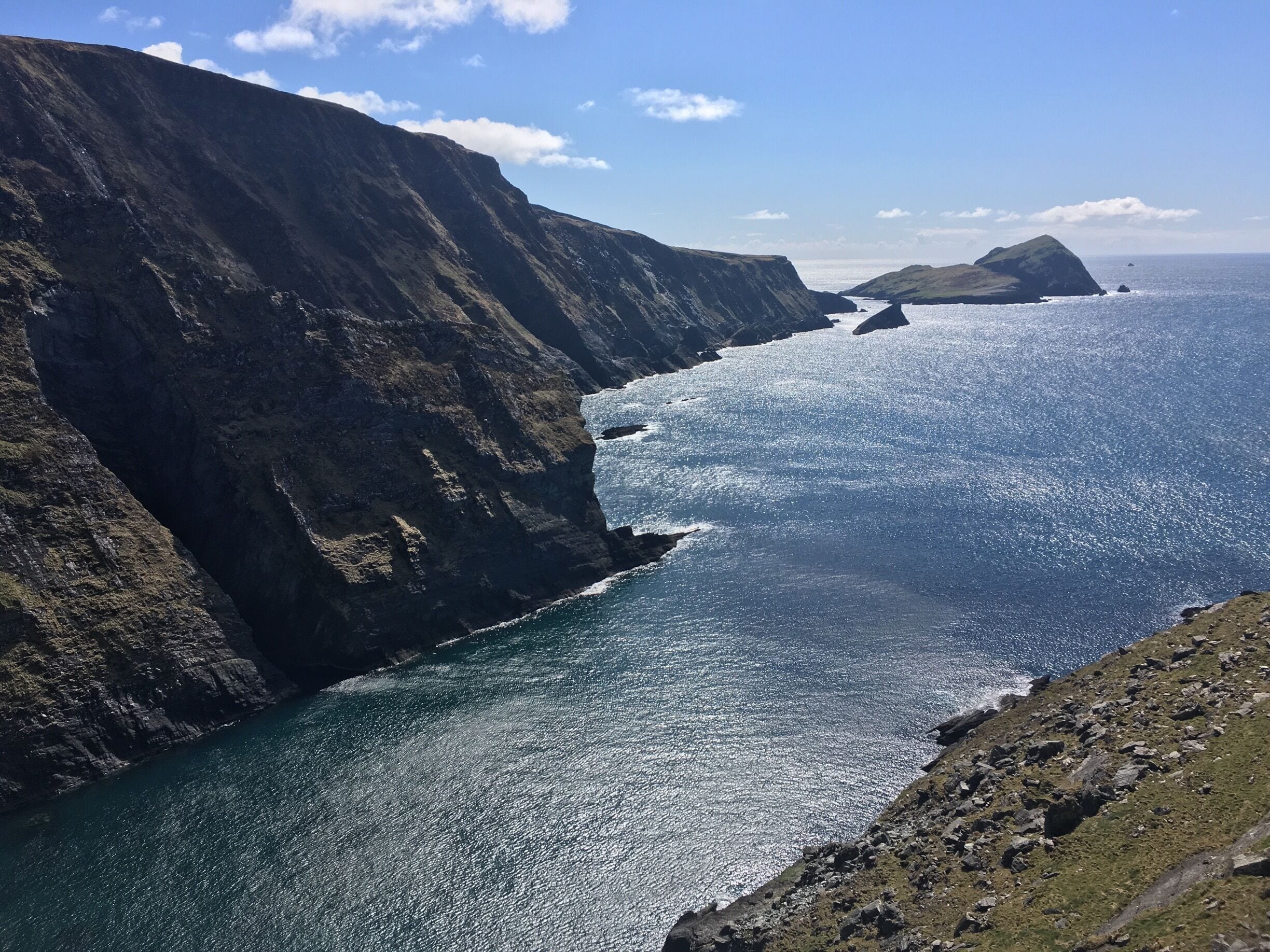A rugged coastline with steep cliffs and a narrow sea passage.