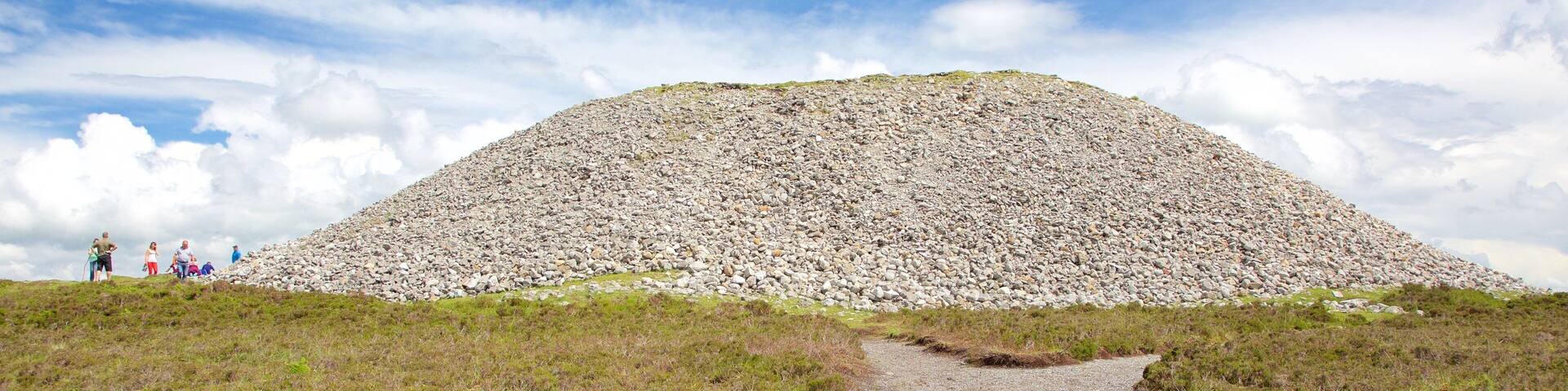 A large mound of rocks with a gravel path leading up to it.