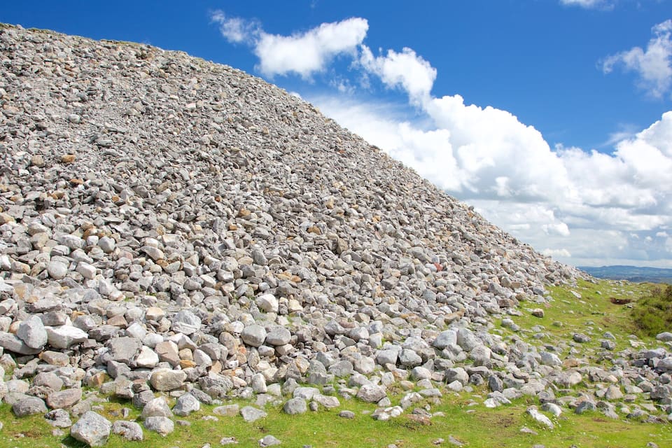 A large pile of rocks under a clear sky.