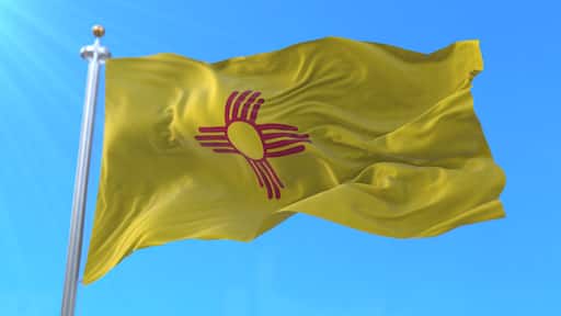 Flag of american state of New Mexico, region of the United States, waving at wind