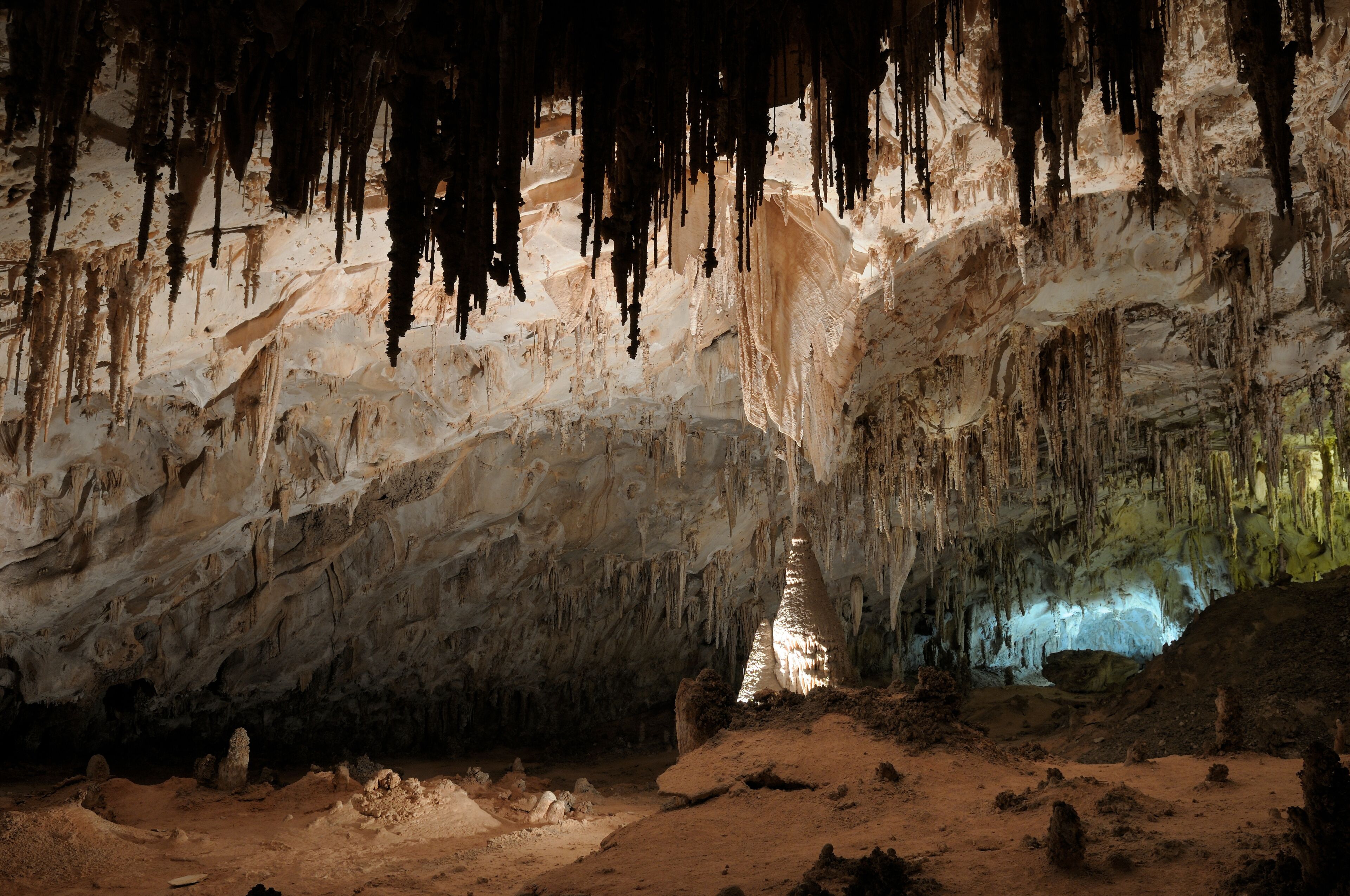 A cave with stalactites and a central column.