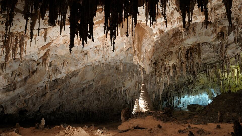 A cave with stalactites and a central column.