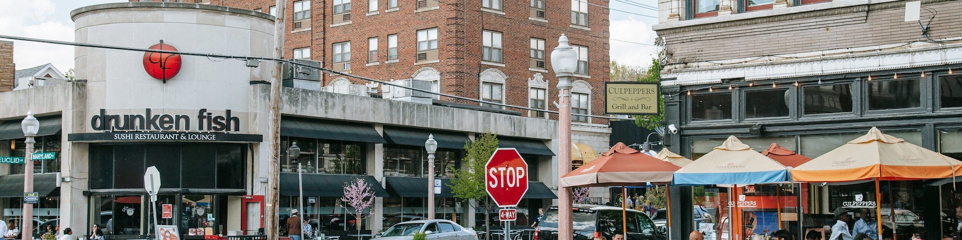 Central West End featuring outdoor eating and a city as well as a small group of people