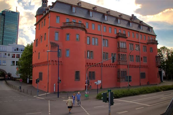 Buesing Palais which includes heritage architecture, a sunset and a city