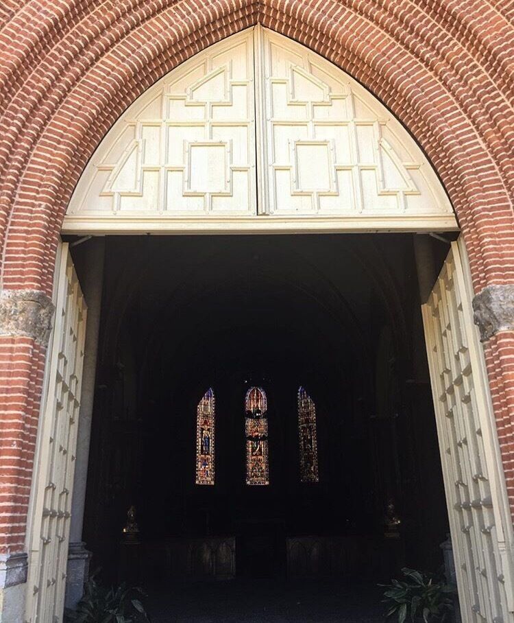 A Gothic-style entrance with a pointed arch and intricate tracery.