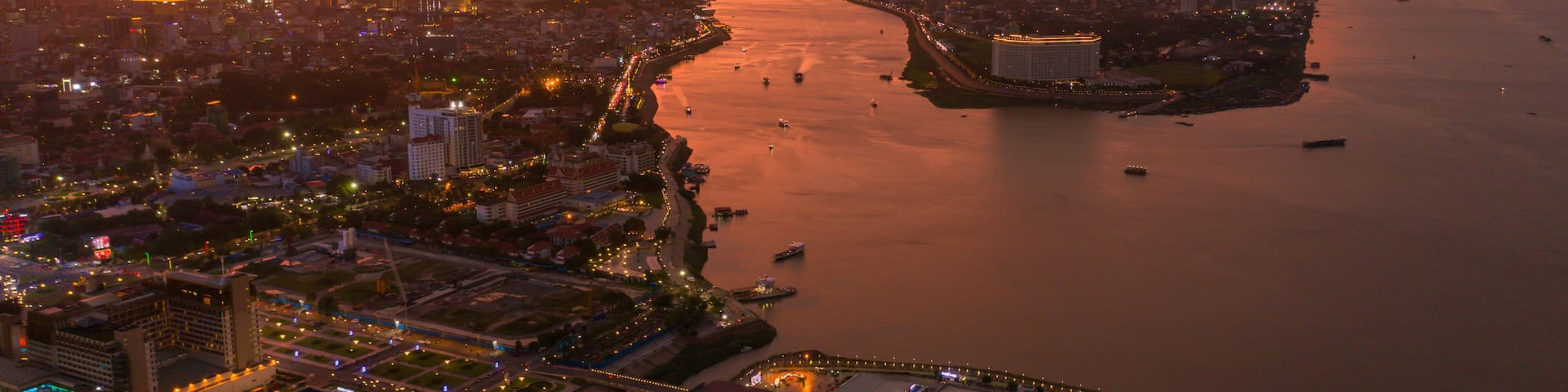 Top View of Building in a City - Aerial view Skyscrapers flying by drone of Phnom Penh city with downtown , riverside and sunset