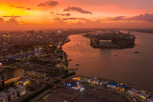 Top View of Building in a City - Aerial view Skyscrapers flying by drone of Phnom Penh city with downtown , riverside and sunset