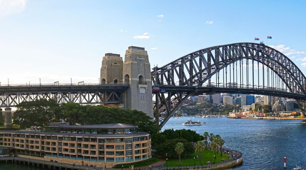Panoramic view of Sydney harbor bridge and North Sydney, boats sailing in the bay and Parramatta River. Evening Light