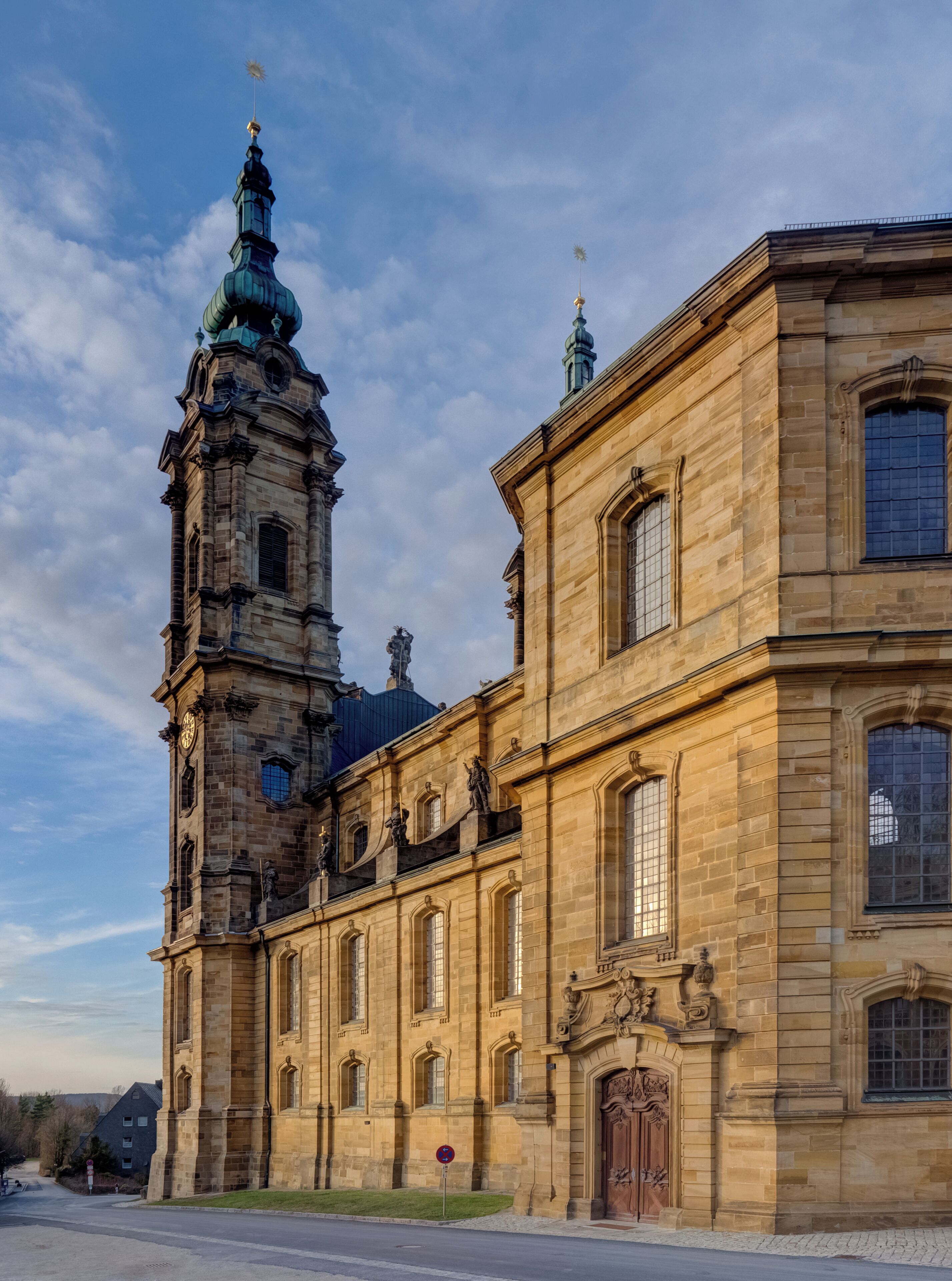 A historic building with a prominent tower and intricate architectural details.