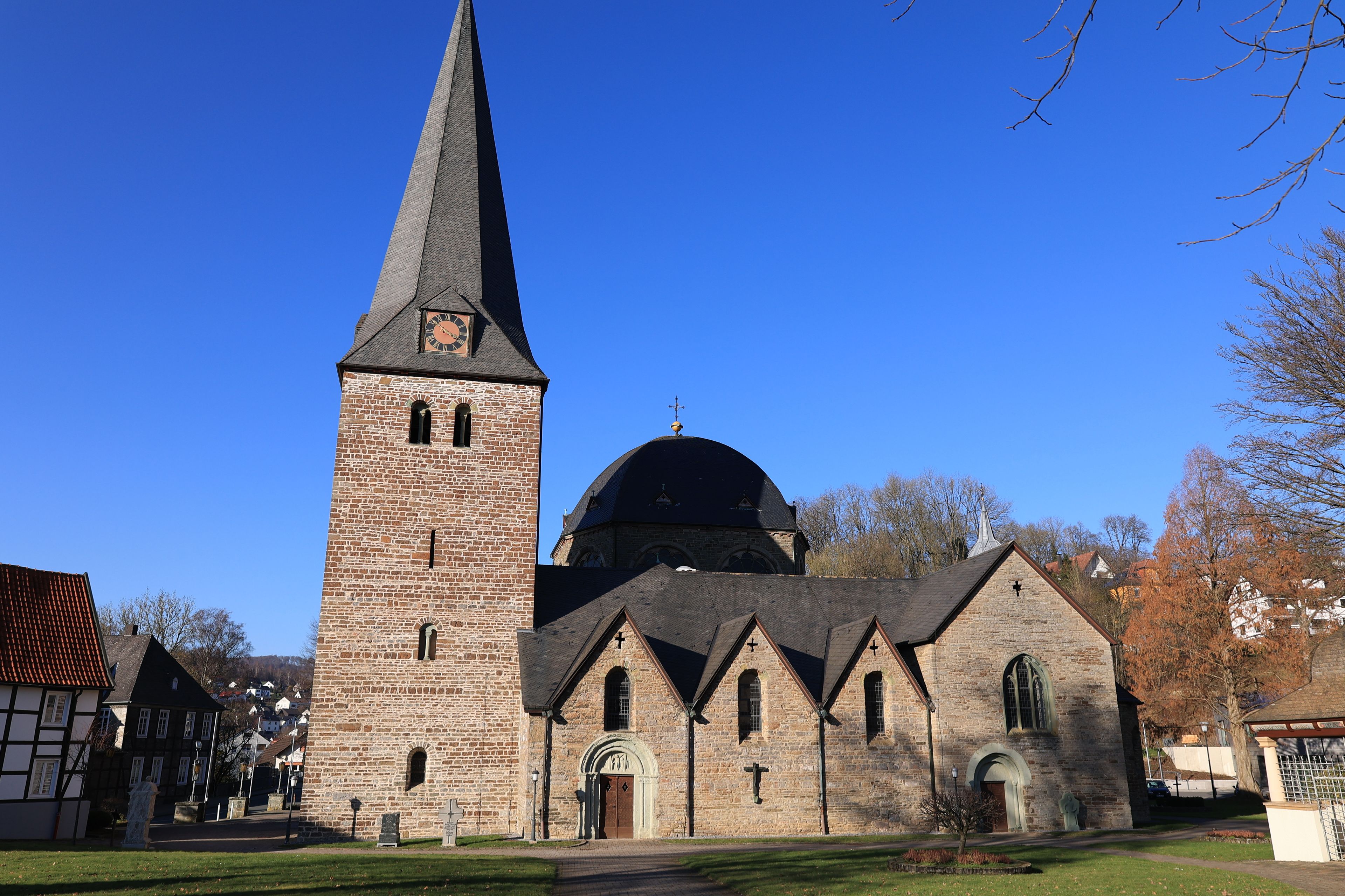 A church with a tall tower and a dome.