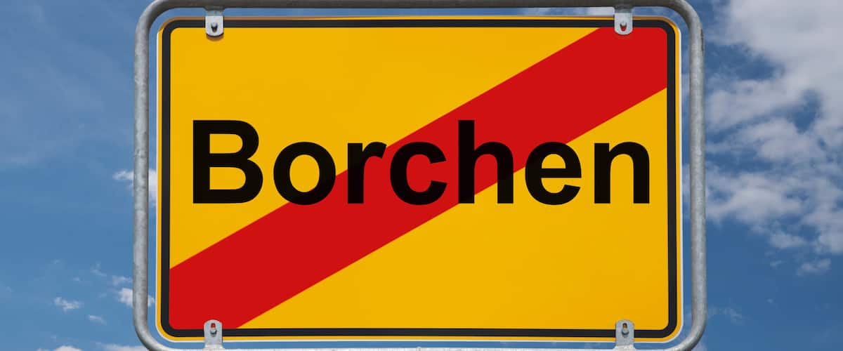 A road sign with the word "Borchern" against a blue sky with clouds.