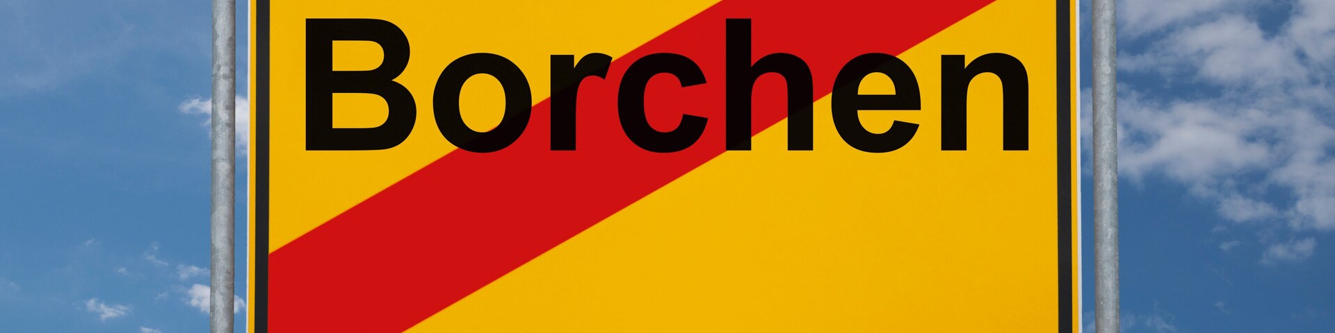 A road sign with the word "Borchern" against a blue sky with clouds.