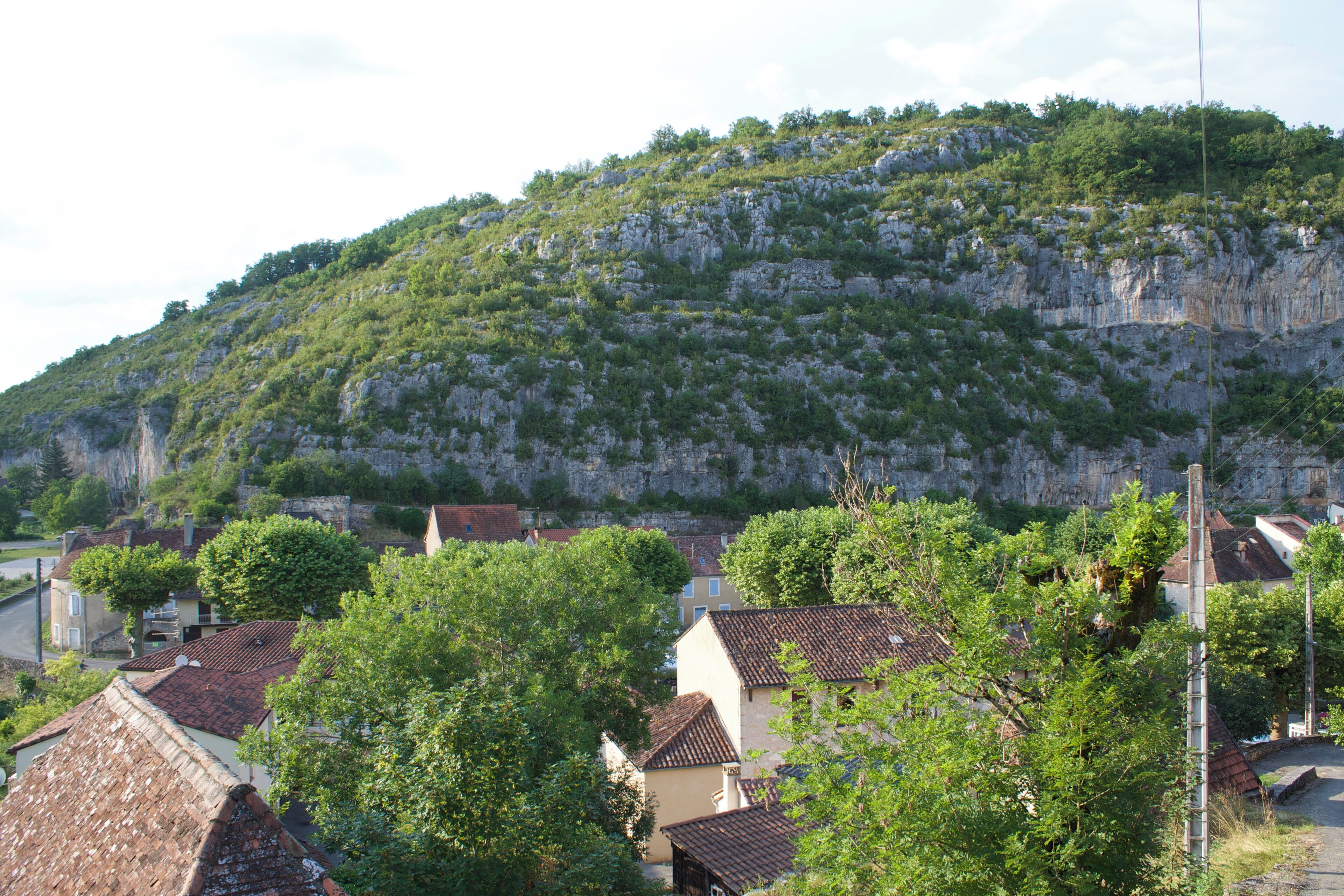 A hillside village with terraced houses and a prominent church.