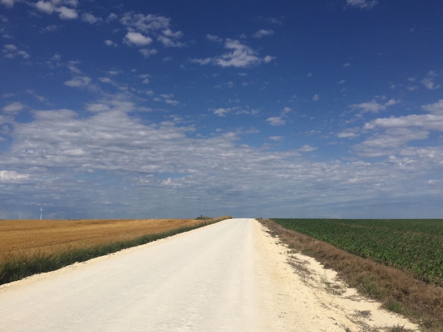Peaceful country in western Kansas. Limestone roads with golden wheat on one side and green corn on the other.