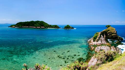 panorama view from hill top at Kapas Island, Terengganu, Malaysia surrounded by crystal clear water, coral, island and blue sky background.