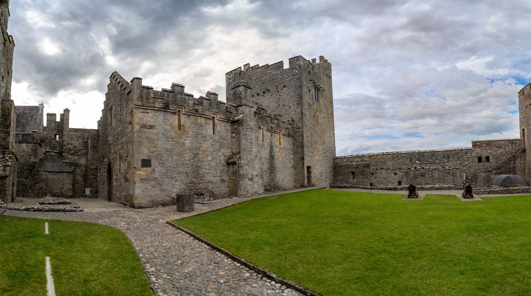 Inner courtyard of Cahir castle with great gothic hall and rectangular tower in Ireland
