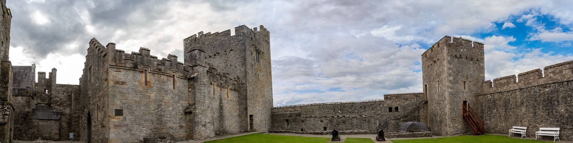 Inner courtyard of Cahir castle with great gothic hall and rectangular tower in Ireland