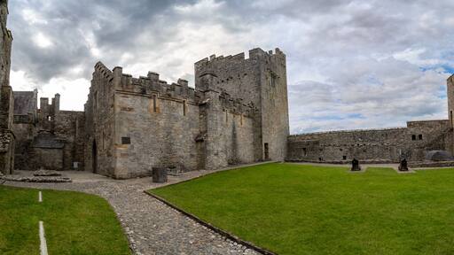 Inner courtyard of Cahir castle with great gothic hall and rectangular tower in Ireland