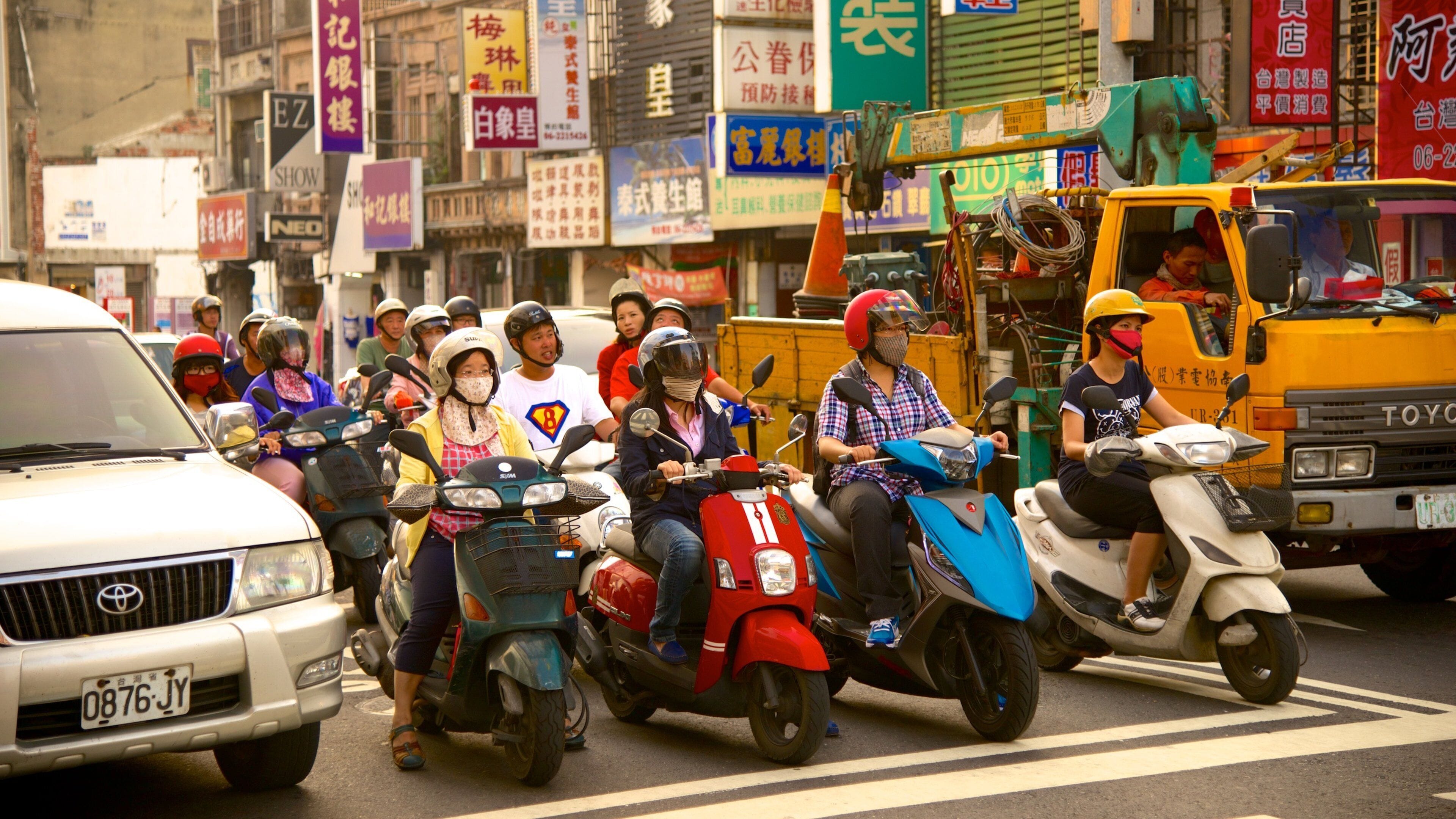 Tainan which includes a city, motorcycle riding and signage