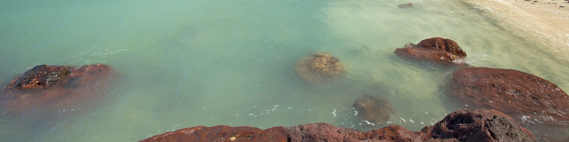 Breathtaking view of Nacula Island with turquoise waters and rocky shoreline in Fiji's Western Division