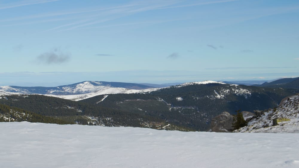 A snow-covered mountain range with clear skies.