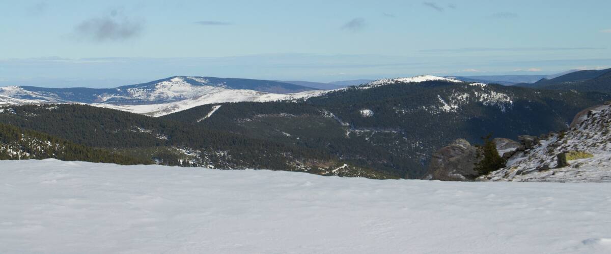 A snow-covered mountain range with clear skies.