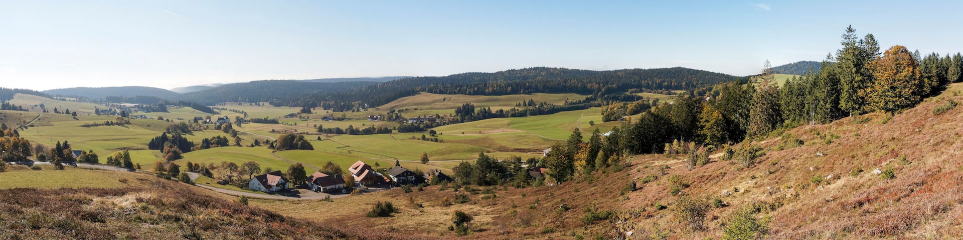 Rolling hills, a village, and a clear sky.