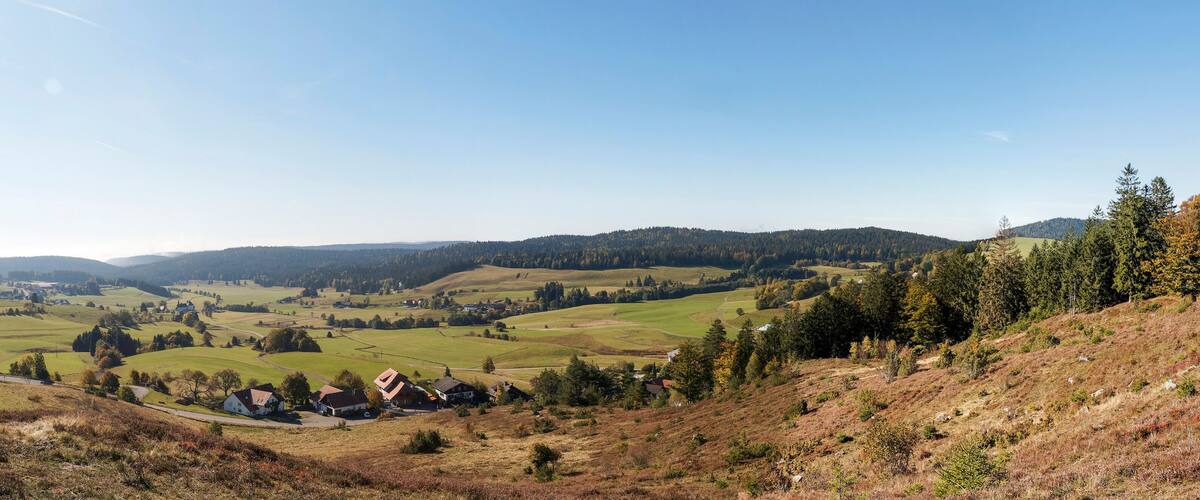 Rolling hills, a village, and a clear sky.