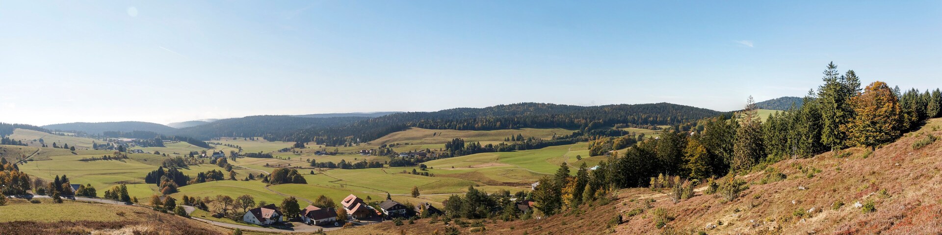 Rolling hills, a village, and a clear sky.