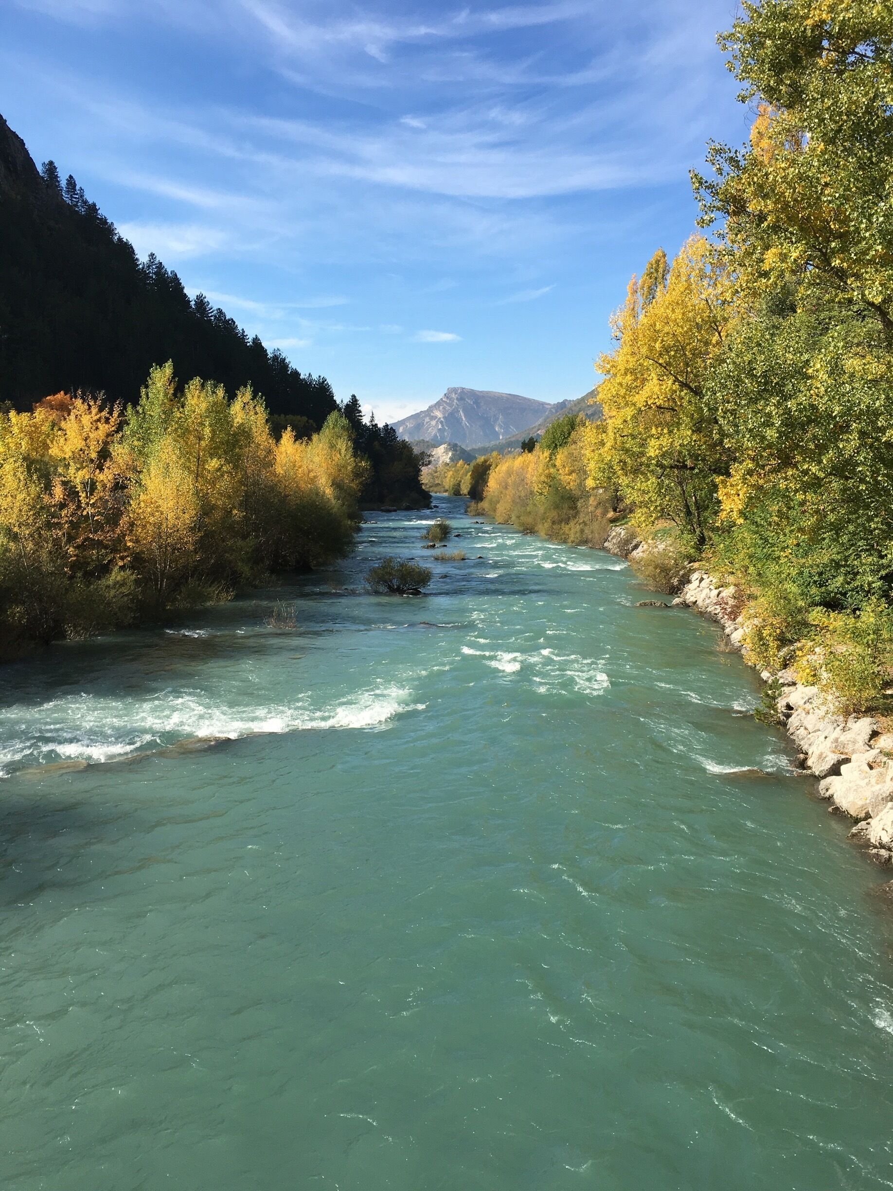 Autumn in the French Alps. Verdon river flowing through the village of Catellane. 
