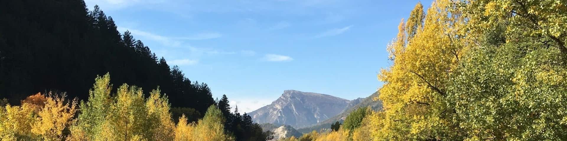 Autumn in the French Alps. Verdon river flowing through the village of Catellane.