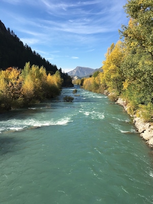 Autumn in the French Alps. Verdon river flowing through the village of Catellane.