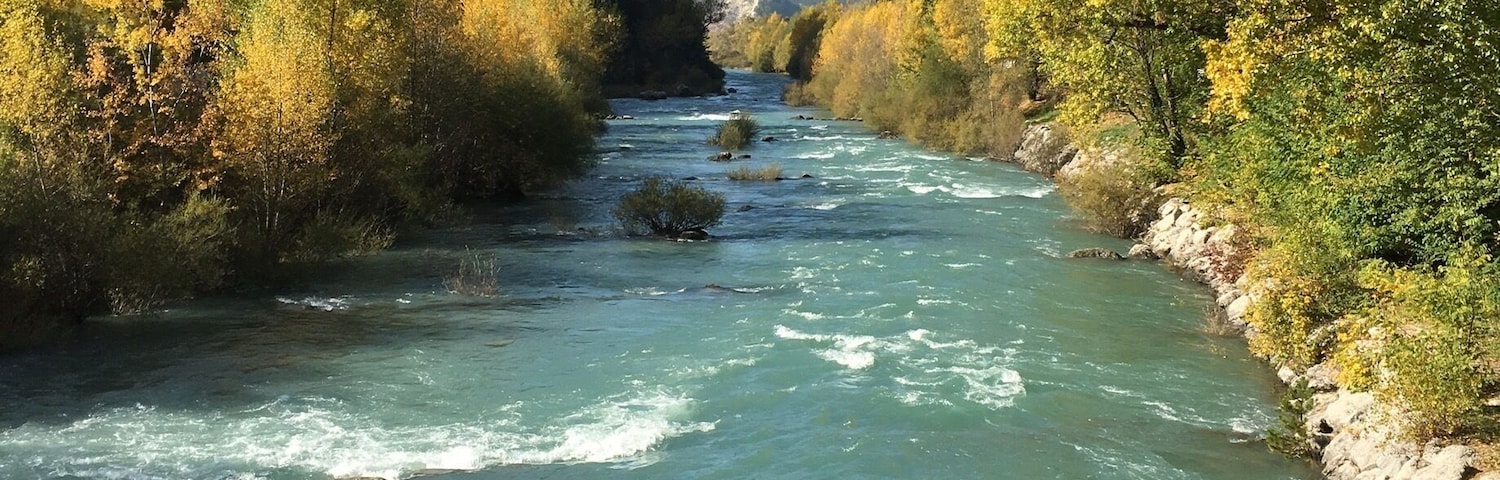 Autumn in the French Alps. Verdon river flowing through the village of Catellane.