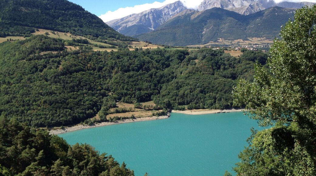On our first road trip via motorbike through France. Stunning blue lake with the Alps in the background.