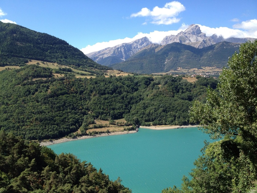 On our first road trip via motorbike through France. Stunning blue lake with the Alps in the background.