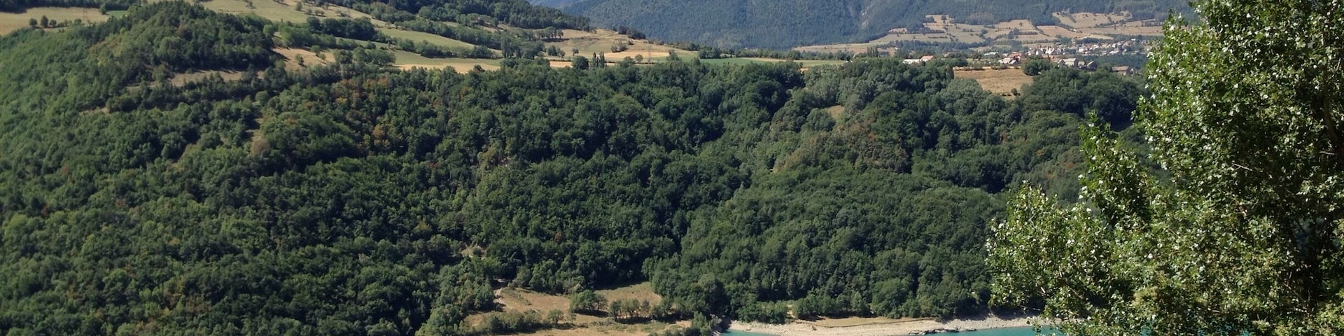 On our first road trip via motorbike through France. Stunning blue lake with the Alps in the background.