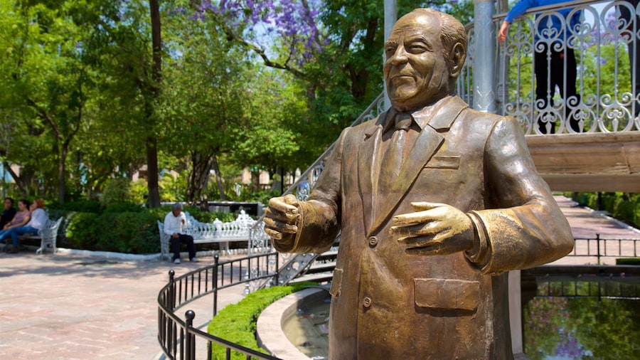 Jardin de San Marcos featuring a square or plaza, a statue or sculpture and a park