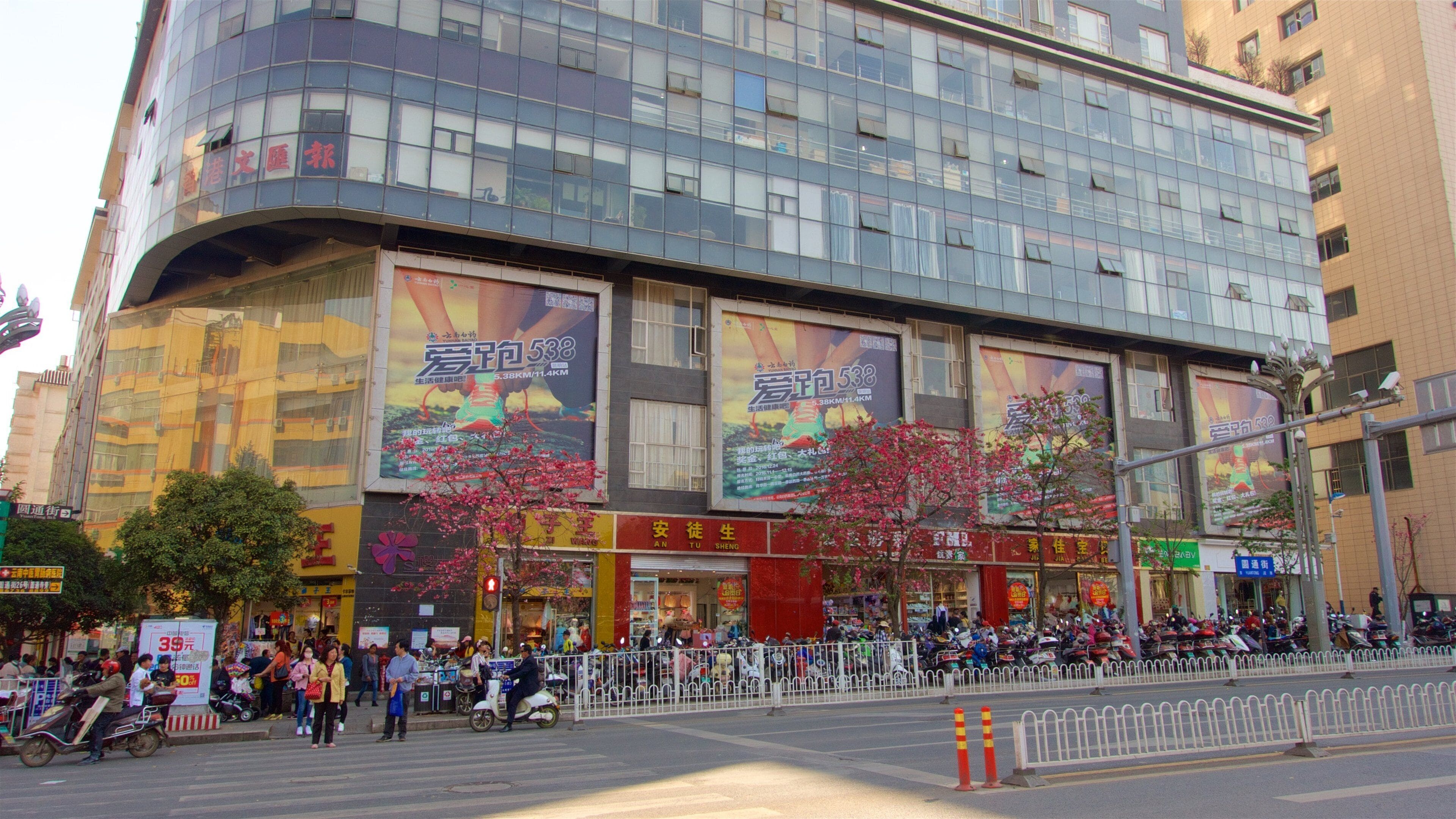 Kunming featuring a city and signage as well as a small group of people