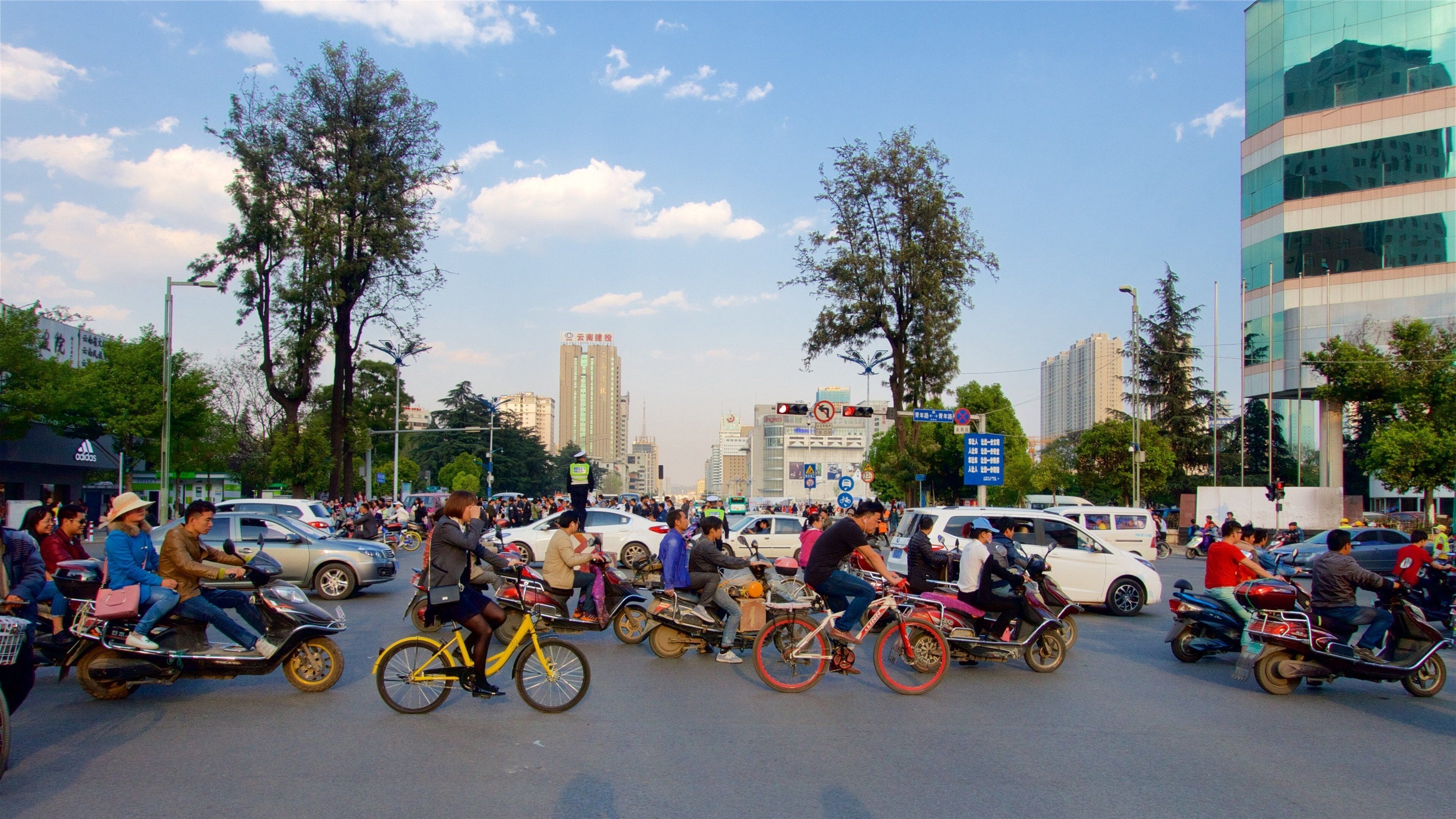 Kunming showing a sunset, a city and cycling