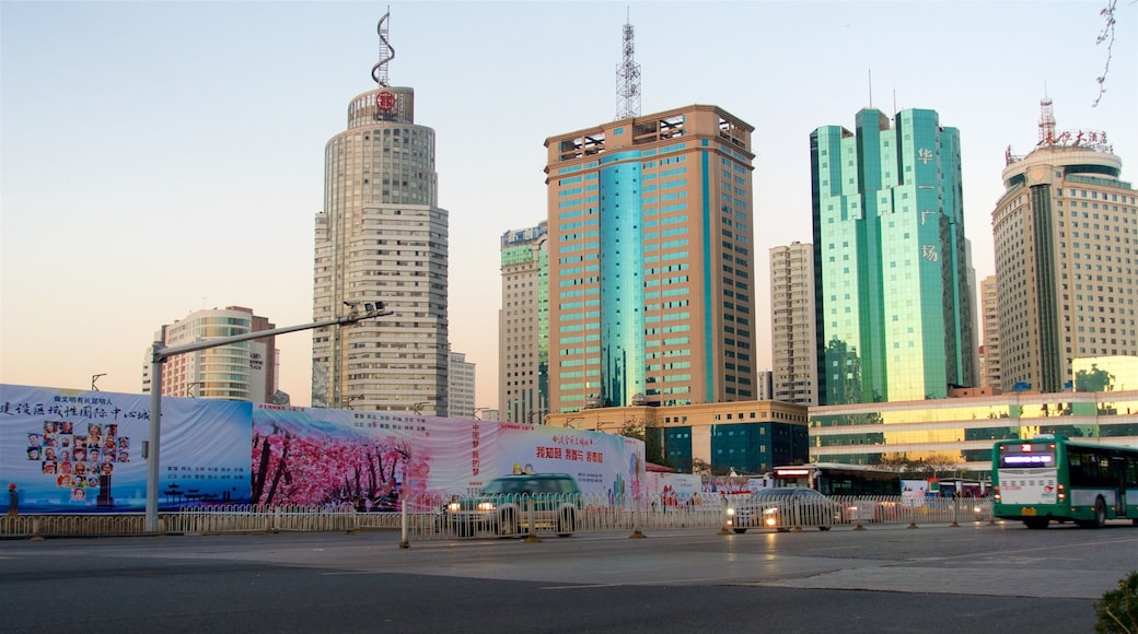 Kunming which includes a city, a high-rise building and a sunset