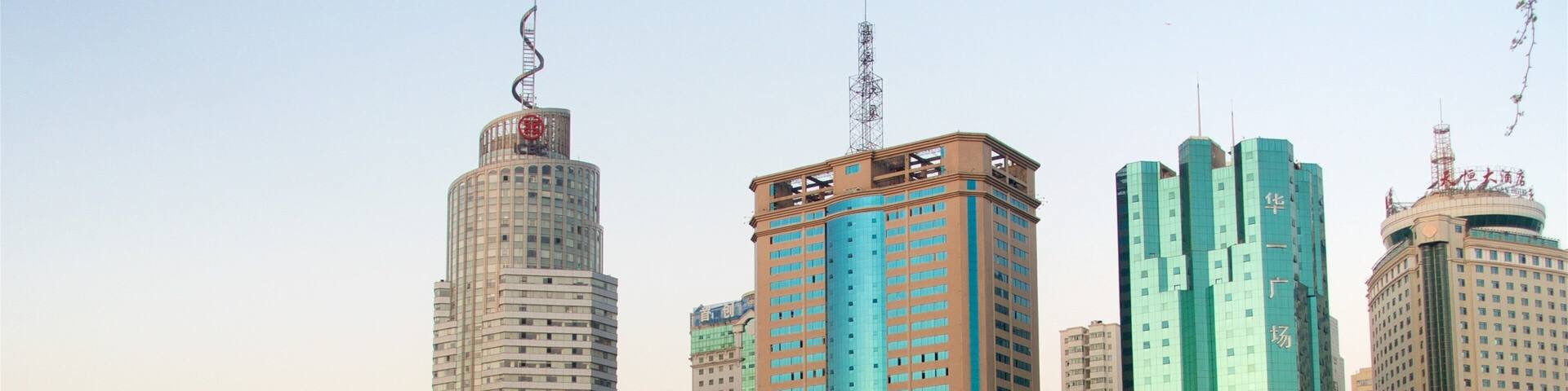 Kunming showing a high rise building, a sunset and a city